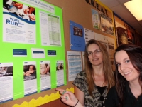 volunteer-becky-howie-with-a-co-worker-next-to-the-store's-livewell-board